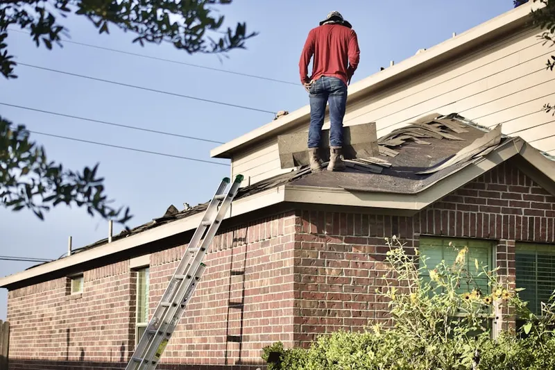 Professional roofer working on a residential roof in Buckhall